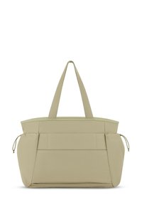 Torba tote w jasnym beżowym materiale, z dwiema mocnymi uchwytami, zamek błyskawiczny u góry oraz przednimi kieszeniami z widocznymi szwami i akcentami w postaci sznureczków.