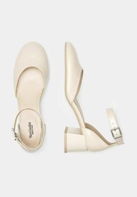 Scarpe con tacco alto in vernice beige, con punta arrotondata, cinturino alla caviglia e tacco a blocco. Texture liscia e design minimalista.