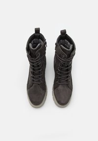 Dark gray ankle boots with suede texture, rounded toe, prominent lacing, dual zip closures, and a thick rubber sole.