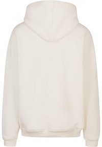 Hoodie in gebroken wit, met een relaxte pasvorm. Heeft een zachte stof, verlaagde schouders en ribgebreide manchetten. Naadloze achterkant zonder versieringen.