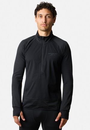 Black zip-up long-sleeve top made from a textured fabric. Features a high collar and thumbholes in sleeves. Subtle logo on chest.
