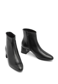 Pair of black leather ankle boots with side zippers and block heels on a white background.