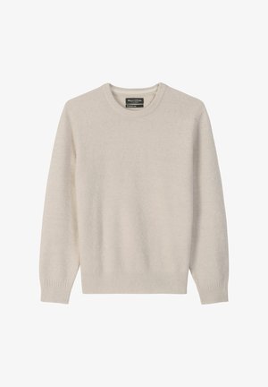 Pull en beige clair, col rond, texture douce, manches longues, bords-côtes aux poignets et à l'ourlet, étiquette au niveau du col. Design simple et dépouillé.