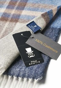 Cashmere scarf featuring a plaid pattern in blue, brown, and gray. Includes tags stating "100% Cashmere" and "Prince Bowtie."