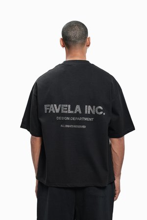 Black oversized t-shirt featuring "FAVELA INC." in rhinestones on the back, with short sleeves and a crew neckline.