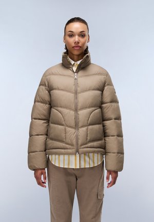 Beige pufferjack met een rits aan de voorkant, hoge kraag en gestikte patroon. Gecombineerd met een gestreept shirt, wat een gelaagd uiterlijk laat zien.