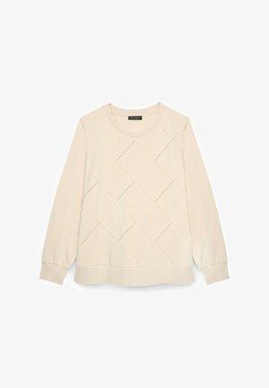 Jasno beżowa bluza z wzorem w romby, okrągły dekolt, długie rękawy oraz ściągacze u rękawów i na dole. Miękka tekstura materiału.