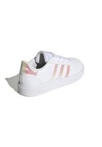 White leather sneaker with three pastel-colored stripes, round toe, textured rubber sole, and branded detailing on the heel.