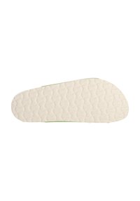 Schuhsohle in hellem Creme mit strukturiertem Muster und grünen Akzenten. Flache Form mit abgerundeten Kanten, die für Traktion und Komfort ausgelegt ist.