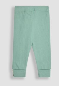 Pantalons vert menthe à côtes avec taille élastique et ourlets boutonnés. Présente des accents en bouton près de la cheville. Tissu doux, design ajusté.