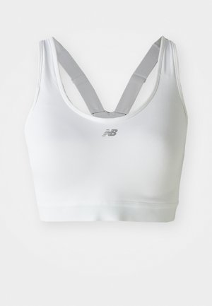 Bílá sportovní podprsenka New Balance s šedými nastavitelnými ramínky ve stylu racerback a logem umístěným na přední straně.