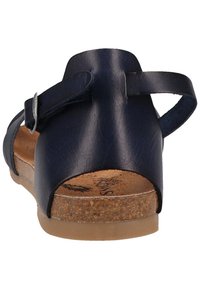 Granatowe skórzane sandały z regulowanym paskiem na kostkę, korkową wkładką i gumową podeszwą. Tylny widok podkreśla detal w postaci pasków.