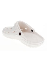 White slip-on clog made of lightweight material, featuring ventilation holes, a raised heel, and a textured outsole for grip.