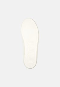 White rubber shoe sole with textured surface, featuring raised "CAMPER" logo. Rounded shape and smooth edges. Minimalist design.
