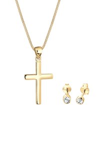 Set di gioielli tono oro composto da una collana con pendente a croce e orecchini a bottone abbinati con pietre trasparenti, superfici lisce e un design elegante.
