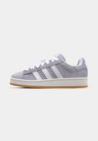 Gray suede sneakers with white three-stripe design, round toe, white laces, and a gum rubber outsole. Accented with perforations on the sides.