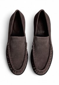 Gray suede moccasin shoes with a smooth texture, rounded toe, and decorative stitching along the edges. Rubber outsole for grip.