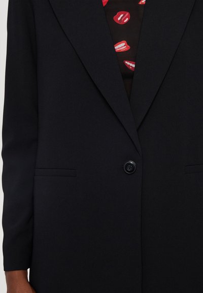Black tailored blazer with notched lapels, single button closure, and two front pockets. Smooth fabric with a matte texture.