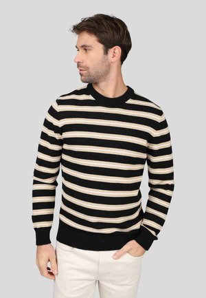 Pull rayé avec des lignes horizontales noires, beiges et crème, col rond, poignets et ourlet côtelés. Fabriqué dans un tissu tricoté doux et texturé.