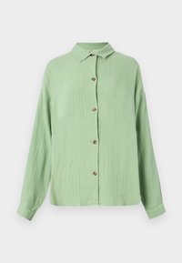 Světle zelená košile s límečkem a knoflíky, dlouhé rukávy a hnědé knoflíky vpředu. Casual střih a jemný povrch.