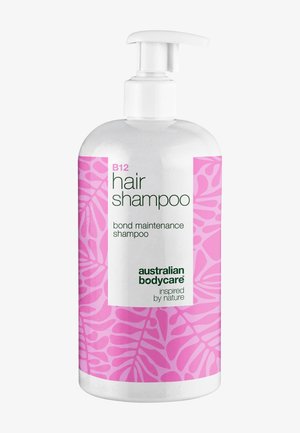 Flacon-pompe blanc du shampooing capillaire B12 d'Australian Bodycare avec motif de feuilles roses et texte indiquant un shampooing pour l'entretien des liens.