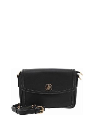 Sac bandoulière en cuir noir avec fermeture à rabat, accent logo doré, coutures blanches et bandoulière réglable. Forme rectangulaire compacte.