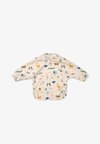 10TH ANNIVERSARY MERLE CAPE BIB UNISEX - Slabbetje - sandy