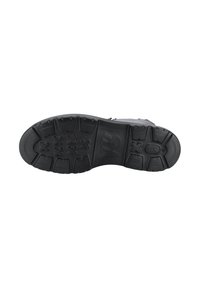 Schwarze Schuhsohle mit robustem Traktionsmuster, das ein leicht erhabenes Logo und hexagonale Akzente für zusätzlichen Halt und Langlebigkeit aufweist.
