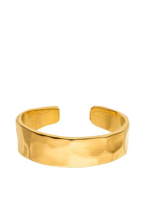 Wide, open-ended gold cuff bracelet with a smooth, slightly hammered texture and a shiny finish on a white background.