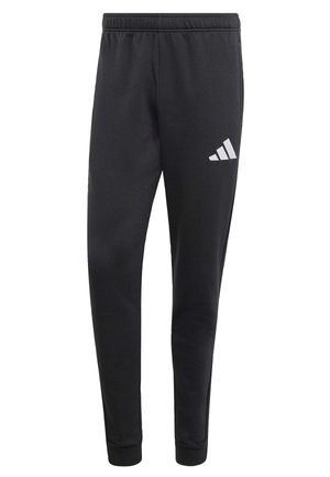 Pantalon de sport noir avec taille élastique, poignets ajustés et logo trois bandes blanc sur la cuisse gauche. Texture de tissu doux.