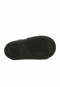 Semelle de chaussure en caoutchouc noir avec un motif de semelle, comportant des zones de grip surélevées, des bords delineés et des sections texturées pour l'adhérence.