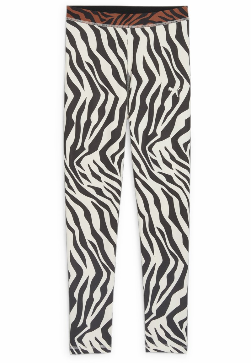 Leggings con stampa zebratica in bianco e nero, con una texture liscia, caratterizzati da una fascia in vita di colore nero e arancione.