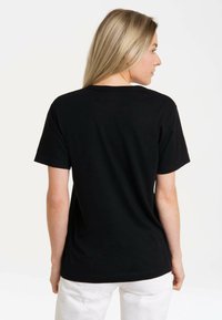 Black cotton t-shirt with a round neck and short sleeves, featuring a smooth texture and a relaxed fit. Back view displayed.