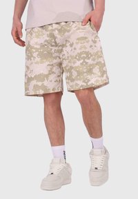 Beige Camo-Shorts aus strukturiertem Stoff, lockerer Passform, seitlichen Taschen und kleinem Logo am Saum. Ideal für den Freizeitlook.