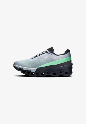 Running shoe in light gray with a green accent, featuring a textured mesh upper, thick black sole with hexagonal cutouts, and flat laces.