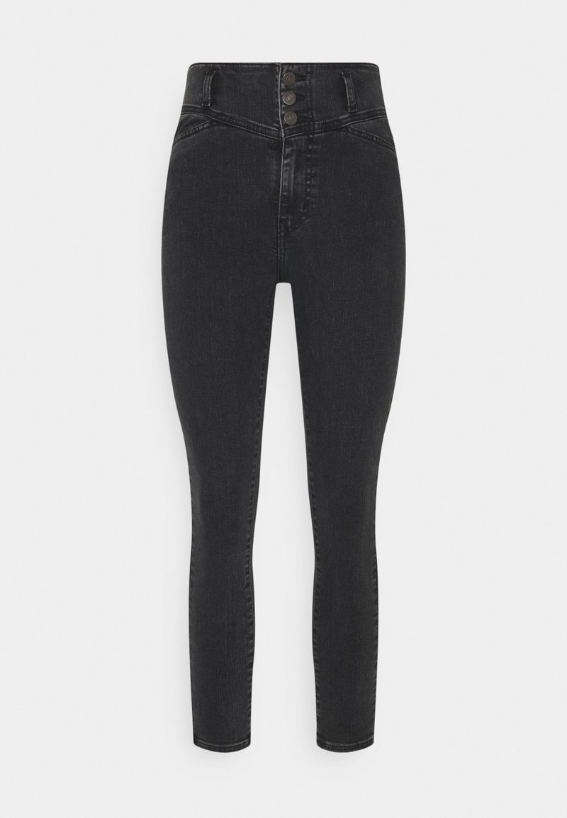 Vaqueros skinny negros de talle alto con tres botones en la parte delantera, bolsillos frontales y un detalle de lavado desvanecido.