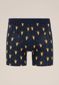 Marinblå boxershorts med ett upprepande mönster av gula giraffhuvuden och blåa regndroppar, tillverkade av mjukt och elastiskt tyg.
