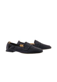 Navy blue suede loafers with rounded toe, front flap detail, and low heel. Soft texture and minimalist design.