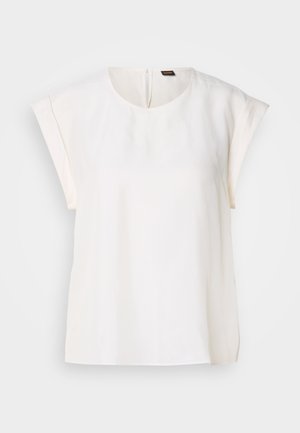 Valge lühikeste varrukatega pluus, millel on ümar kaelus, sile kangas ja nähtamatu tagumine lukuga sulgemine. Sirge äär ja mugav lõige.