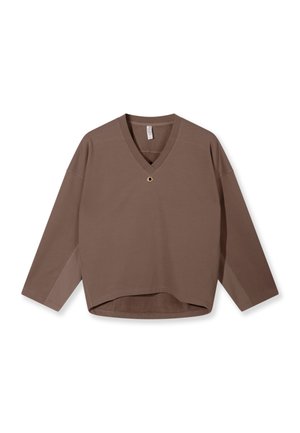 Brown long-sleeve V-neck shirt with relaxed fit, featuring a small round metal eyelet detail near the neckline and a slightly curved hem.
