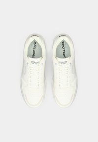 Pair of white Jack & Jones sneakers with laces, viewed from above on a plain light background.