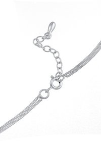 Sølv metalarmbånd med et fint kædedesign, der har en fremstillelås og justerbar længde ved hjælp af forbundne kædeaccentuer.