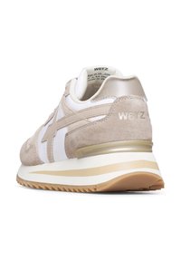 Beżowe zamszowe sneakersy z białymi nylonowymi akcentami i jasnoskalnym wykończeniem. Posiadają teksturowaną podeszwę oraz subtelną logo marki na pięcie.