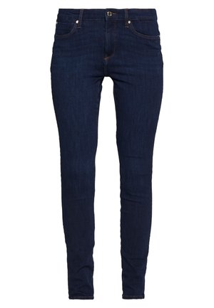 Jeans skinny bleu foncé en denim, dotés d'une fermeture éclair, de poches avant et arrière, et de coutures discrètes.