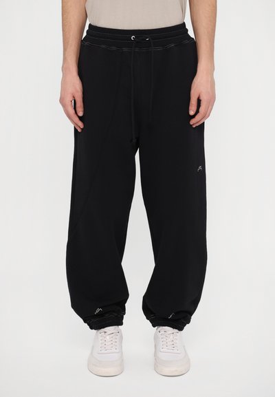 Pantaloni de jogging negri, cu talie elastica si siret, mansete elastice si buzunare laterale. Fabricati dintr-un material neted si usor. Branding minim vizibil.