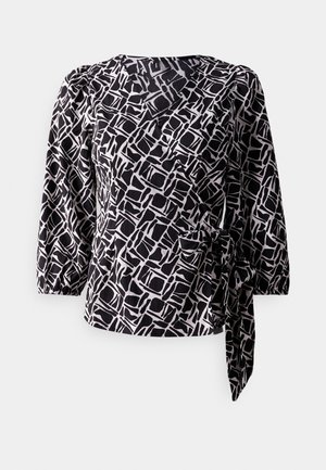 Blouse à motifs noir et blanc avec des manches trois-quarts, design croisé, tissu texturé et un détail de nouage sur le côté.