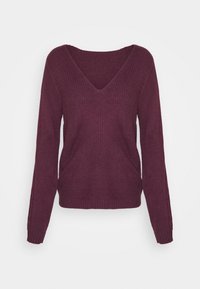 Burgundy stickad tröja med V-ringning, långa ärmar och ribbad textur. Har sidoflikar och en avslappnad passform.