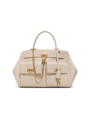 Beige leather handbag with two front pockets, gold-tone lock and chain detail, curved handle, and two dangling keys on a strap.