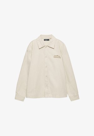 Krémová košeľa s vertikálnymi pruhmi, zapínaná na gombíky, s golierom a hnedou výšivkou "Northern Community" na ľavej strane hrudníka.