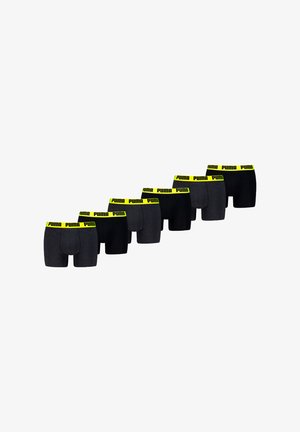 Sechs Paar Boxershorts in verschiedenen Schwarz- und Grautönen, mit einem leuchtend gelben Puma-Bund mit wiederholtem Markenlogo.